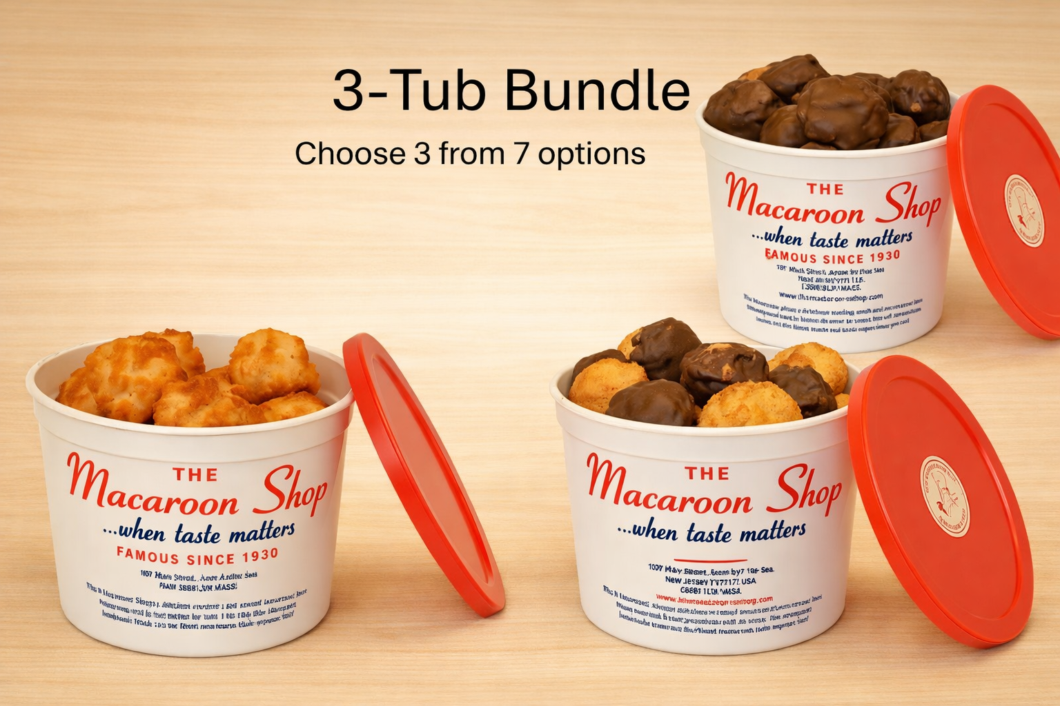 Three tubs of The Macaroon Shop with red lids on a wooden surface.
